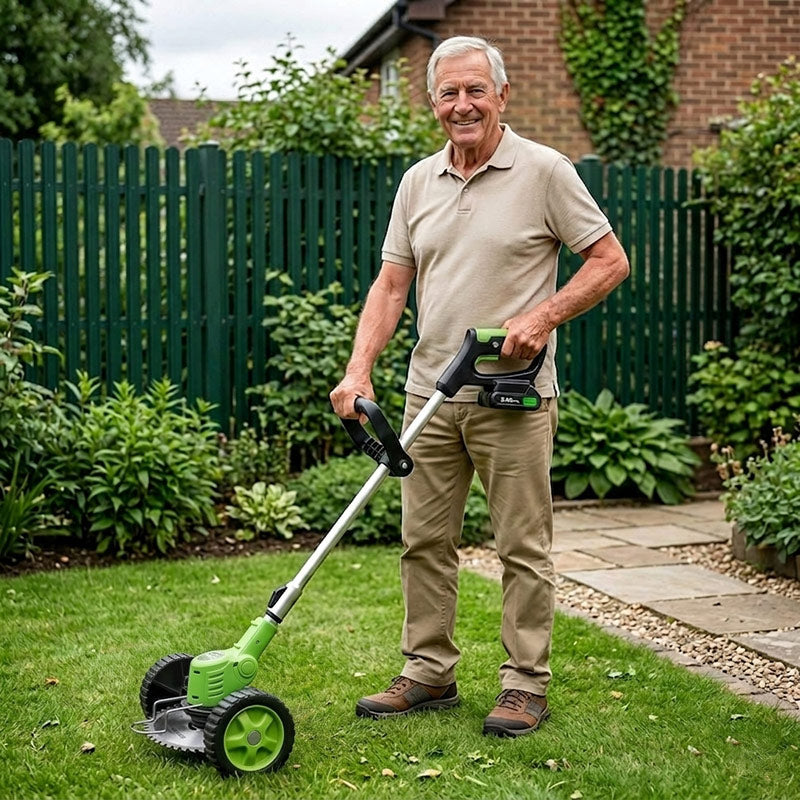 Smiling older man using a green cordless edger with wheels along a garden path