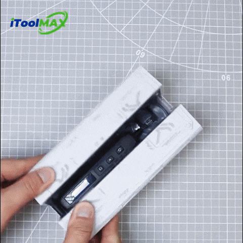 Hands opening a white box holding a compact screwdriver with bits