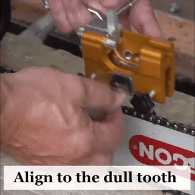 Orange sharpener jig being aligned to a dull chain tooth on a saw bar